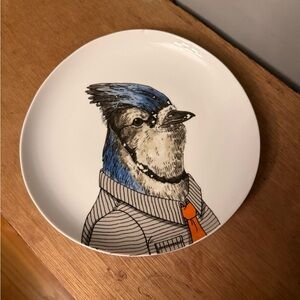 West Elm blue jay dressed in human attire,  a striped shirt and an orange tie.